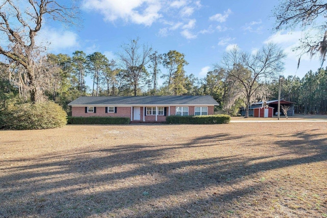 ranch-style house with a carport and a front yard