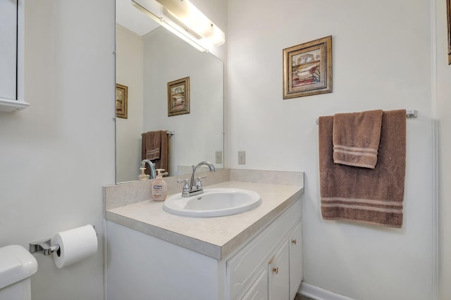 bathroom with toilet and vanity