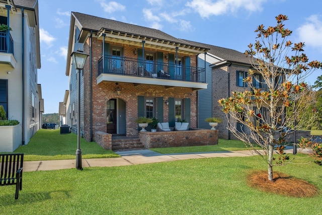 view of front facade featuring cooling unit, a balcony, and a front lawn