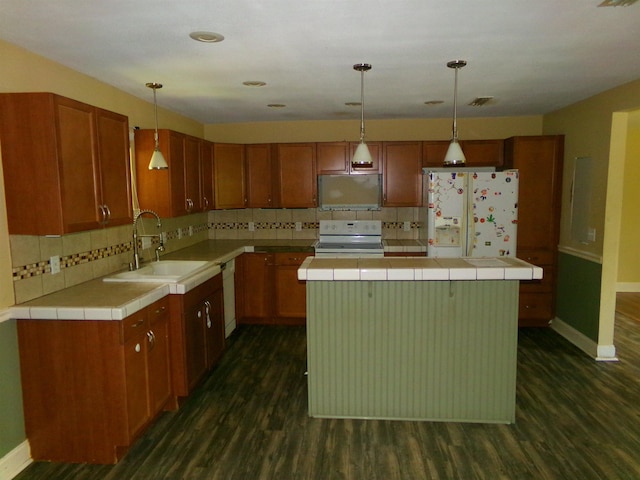 402 W Brent St, Chattahoochee, FL 32324 - kitchen featuring white appliances, dark wood finished floors, decorative backsplash, and tile counters