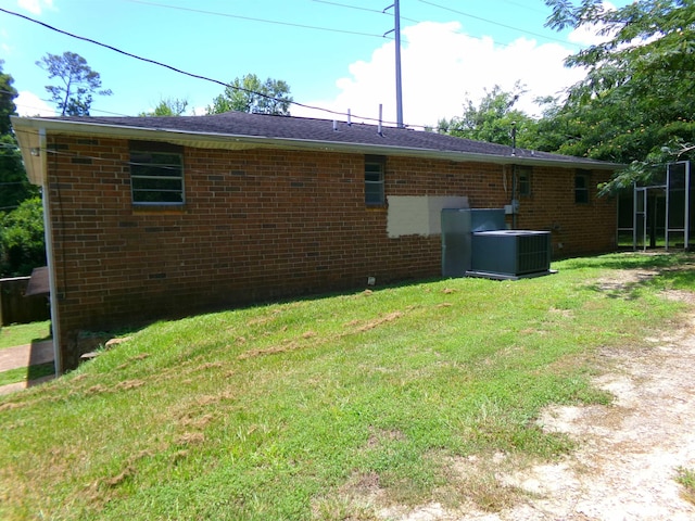 402 W Brent St, Chattahoochee, FL 32324 - rear view of house featuring brick siding and a lawn