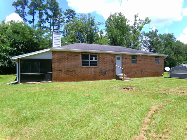 402 W Brent St, Chattahoochee, FL 32324 - rear view of property with entry steps, a chimney, a yard, and brick siding
