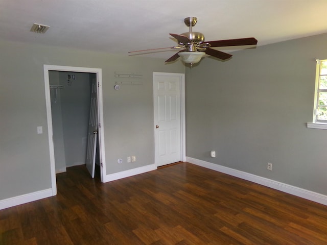 402 W Brent St, Chattahoochee, FL 32324 - unfurnished bedroom featuring a walk in closet, wood finished floors, a closet, and ceiling fan
