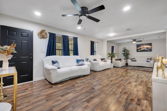 living room with hardwood / wood-style flooring and ceiling fan