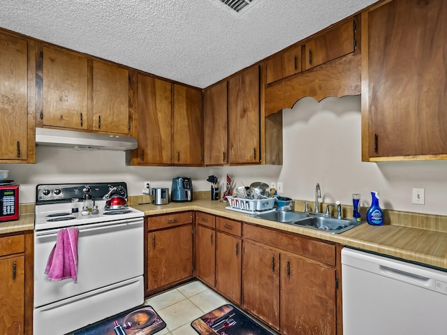 2390 Gregory Dr, Tallahassee, FL 32303 - kitchen with white appliances, under cabinet range hood, a sink, light countertops, and a textured ceiling