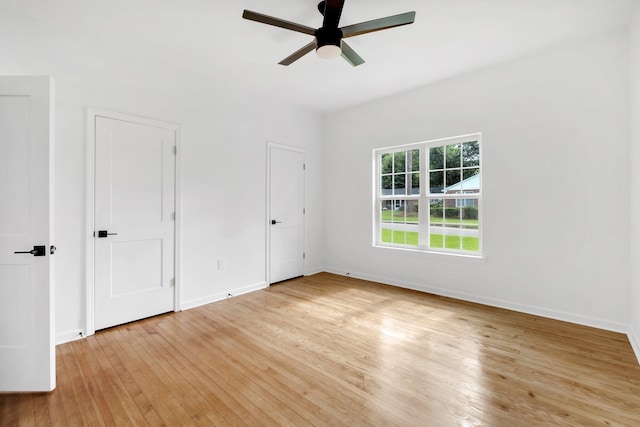 unfurnished bedroom with ceiling fan and light wood-type flooring