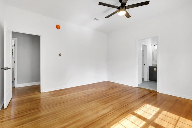 spare room with wood-type flooring and ceiling fan