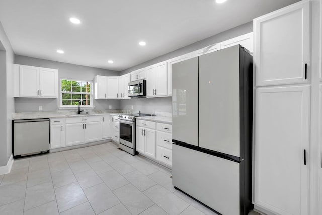 502 N 11th St, Quincy, FL 32351 - kitchen featuring appliances with stainless steel finishes, a sink, light countertops, white cabinetry, and recessed lighting