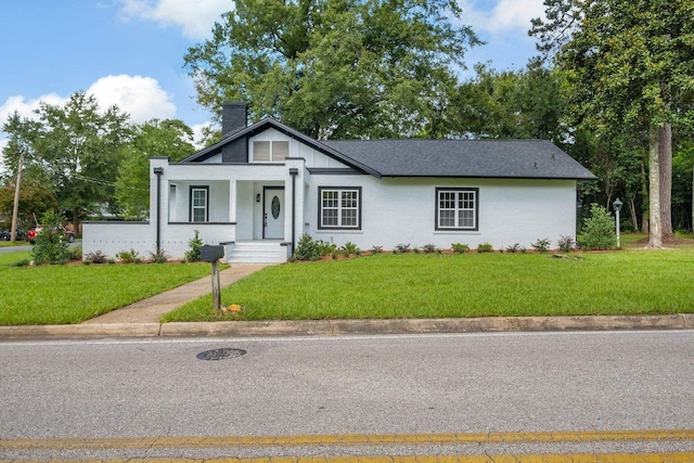 502 N 11th St, Quincy, FL 32351 - view of front of house featuring a chimney, a front lawn, and covered porch