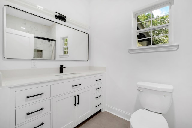 bathroom with toilet, vanity, tile patterned floors, and a shower with door