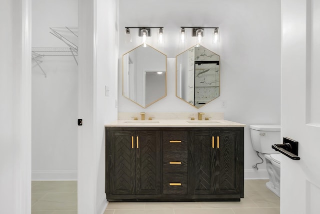bathroom with tile patterned flooring, vanity, and toilet
