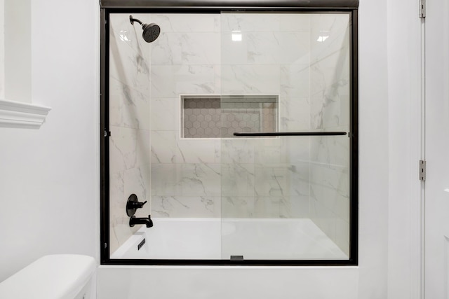 bathroom with enclosed tub / shower combo and toilet