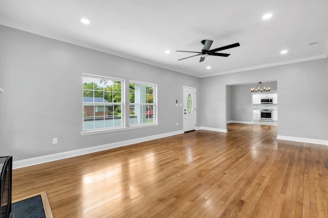 unfurnished living room with hardwood / wood-style floors, ceiling fan with notable chandelier, and ornamental molding