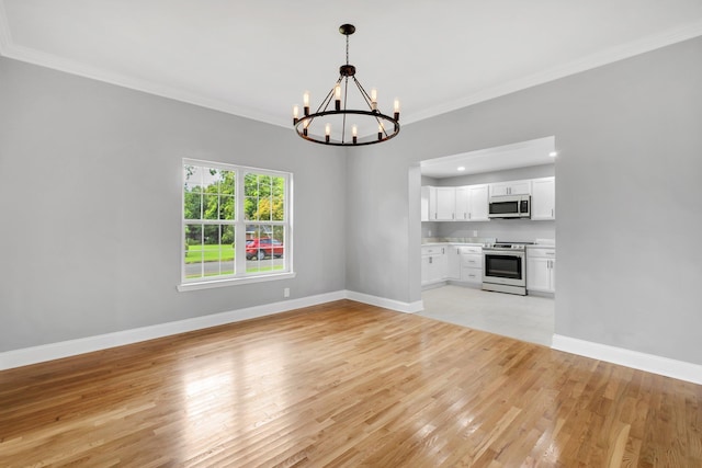 502 N 11th St, Quincy, FL 32351 - unfurnished living room featuring a chandelier, light wood-style flooring, crown molding, and baseboards