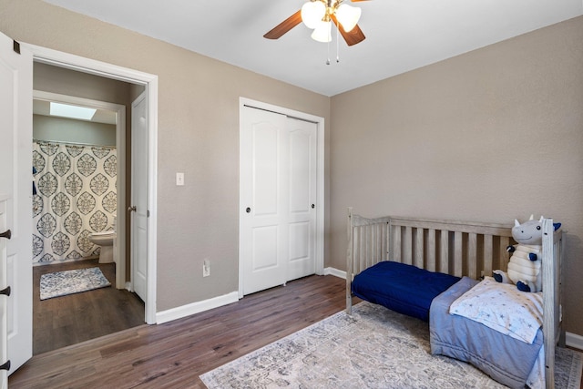 bedroom with a skylight, wood-type flooring, a closet, and ceiling fan