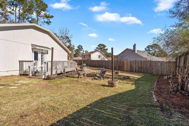 view of yard featuring an outdoor fire pit and a deck