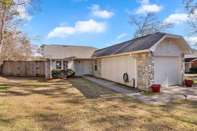 ranch-style home featuring a garage and a front lawn