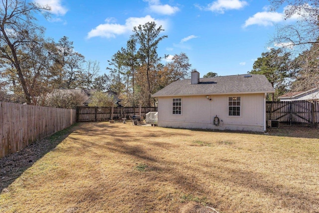 rear view of property featuring a yard