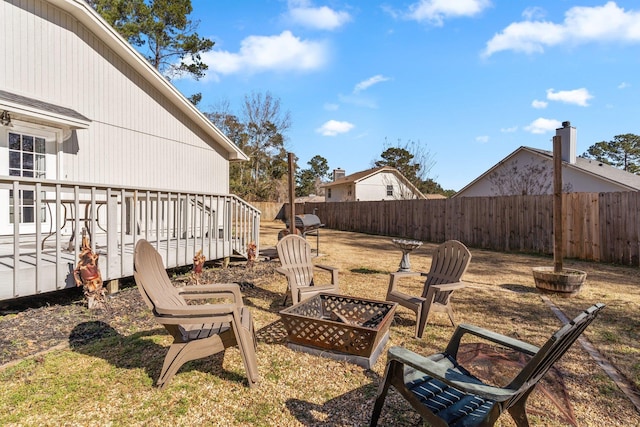 view of yard featuring a wooden deck and a fire pit