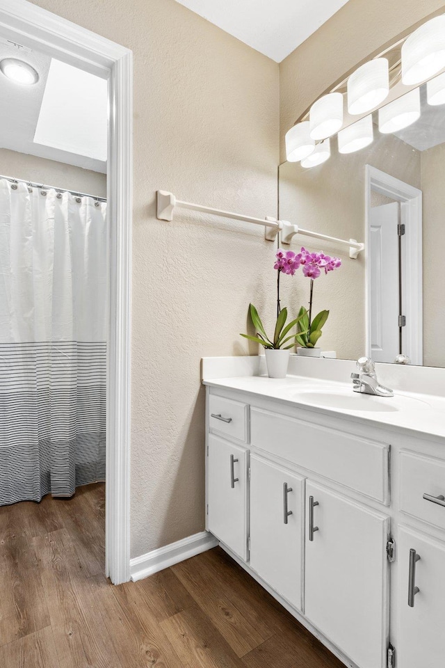 bathroom with vanity and wood-type flooring