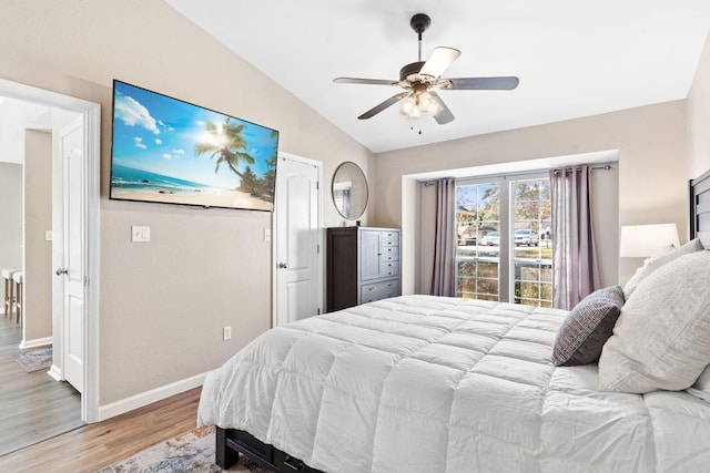 bedroom featuring light hardwood / wood-style flooring, vaulted ceiling, and ceiling fan