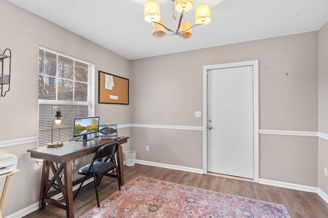 home office featuring dark hardwood / wood-style flooring and a chandelier