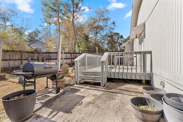 view of patio / terrace featuring a wooden deck and a grill