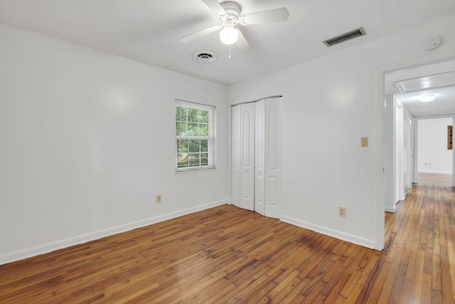 1904 Dahlia Dr, Tallahassee, FL 32304 - unfurnished bedroom with light wood finished floors, baseboards, a closet, and ceiling fan