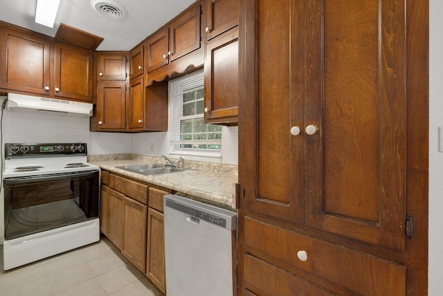 1904 Dahlia Dr, Tallahassee, FL 32304 - kitchen with white range with electric stovetop, under cabinet range hood, dishwasher, a sink, and light countertops