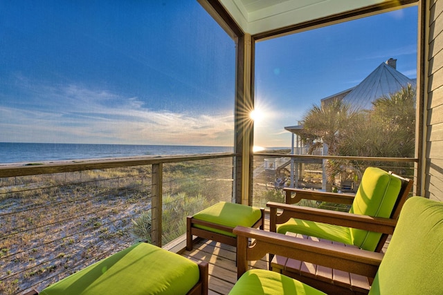 balcony featuring a water view and a view of the beach