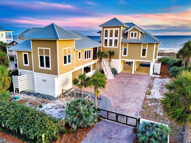 view of front of house with a carport and a water view