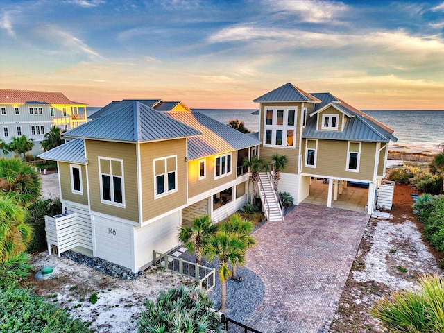 view of front facade featuring a carport and a water view