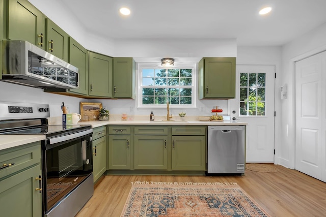 246 Intrepid Ct, Tallahassee, FL 32312 - kitchen with green cabinetry, appliances with stainless steel finishes, a sink, light countertops, and recessed lighting