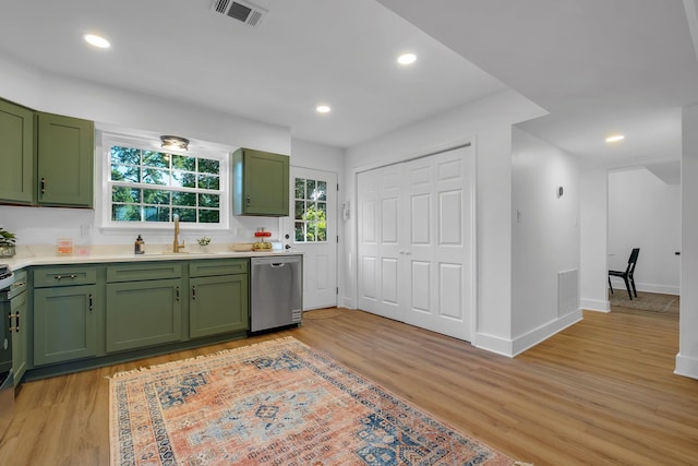 246 Intrepid Ct, Tallahassee, FL 32312 - kitchen with green cabinets, stainless steel dishwasher, a sink, light wood finished floors, and light countertops