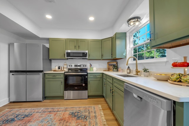 246 Intrepid Ct, Tallahassee, FL 32312 - kitchen featuring stainless steel appliances, green cabinetry, a sink, light countertops, and recessed lighting
