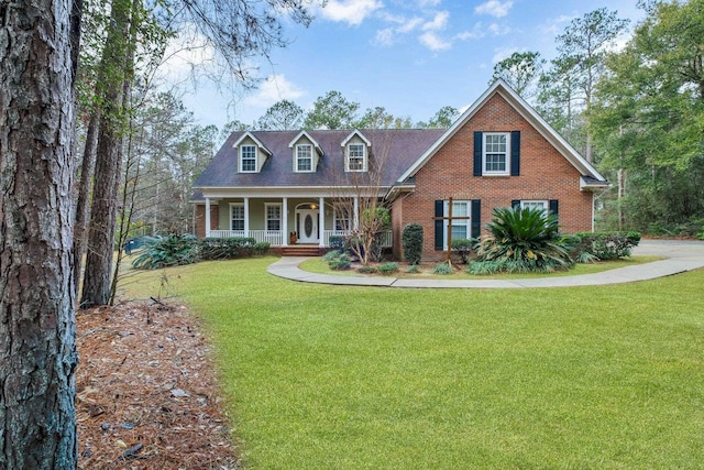 view of front of home with covered porch and a front lawn