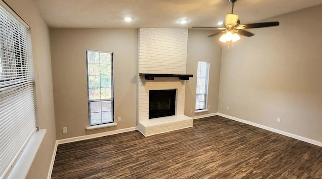 2585 Panther Creek Rd, Tallahassee, FL 32308 - unfurnished living room featuring dark wood-type flooring, plenty of natural light, a ceiling fan, a fireplace, and recessed lighting
