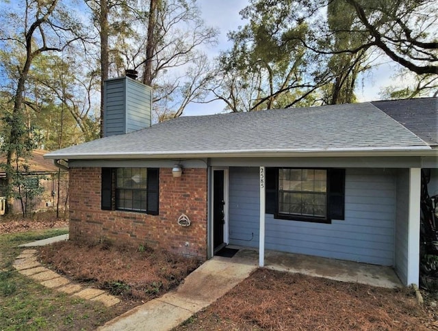 2585 Panther Creek Rd, Tallahassee, FL 32308 - ranch-style home with a chimney, roof with shingles, and brick siding