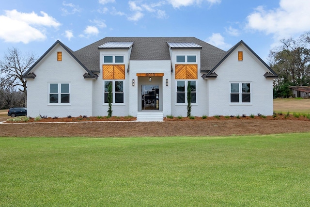 contemporary home with a front lawn