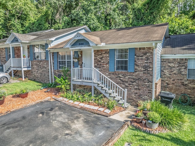 3104 Oak Hammock Ln Unit U, Tallahassee, FL 32301 - ranch-style home with roof with shingles, brick siding, and a porch