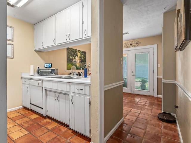 3104 Oak Hammock Ln Unit U, Tallahassee, FL 32301 - kitchen featuring light countertops, white cabinets, dishwasher, and light tile patterned flooring