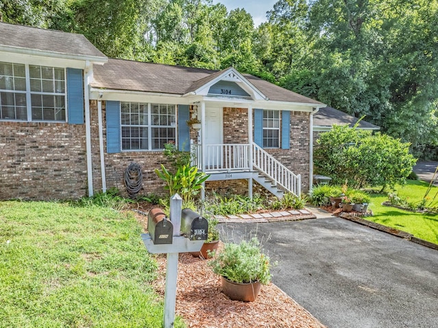 3104 Oak Hammock Ln Unit U, Tallahassee, FL 32301 - ranch-style home featuring brick siding, a front lawn, and a porch