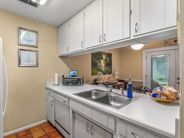 3104 Oak Hammock Ln Unit U, Tallahassee, FL 32301 - kitchen featuring light countertops, dishwasher, white cabinets, light tile patterned flooring, and refrigerator