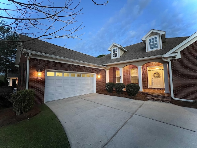 2541 Lagrange Trl, Tallahassee, FL 32312 - view of front facade featuring brick siding, concrete driveway, an attached garage, and roof with shingles