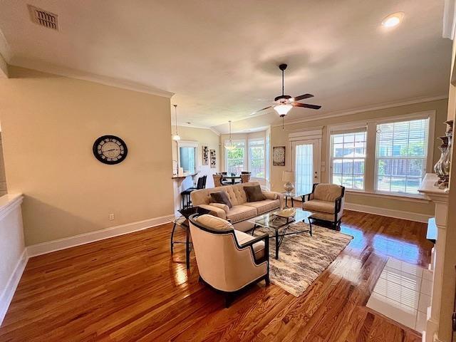 2541 Lagrange Trl, Tallahassee, FL 32312 - living room with dark wood-style flooring, baseboards, ornamental molding, and ceiling fan