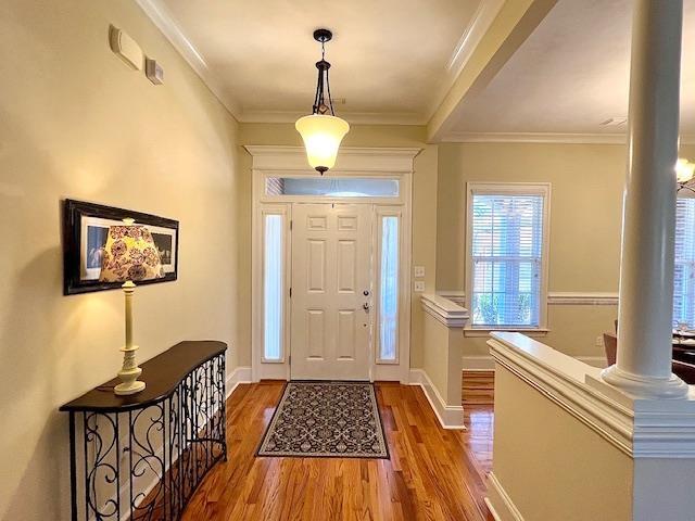 2541 Lagrange Trl, Tallahassee, FL 32312 - foyer with decorative columns, wood finished floors, crown molding, and baseboards