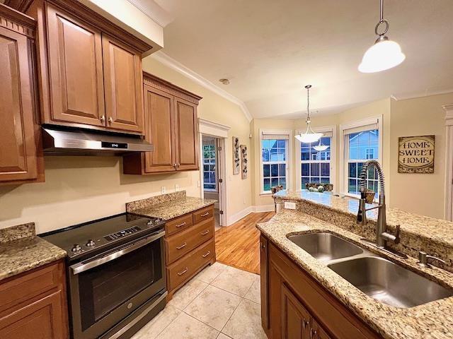 2541 Lagrange Trl, Tallahassee, FL 32312 - kitchen with electric stove, under cabinet range hood, a sink, hanging light fixtures, and light stone countertops
