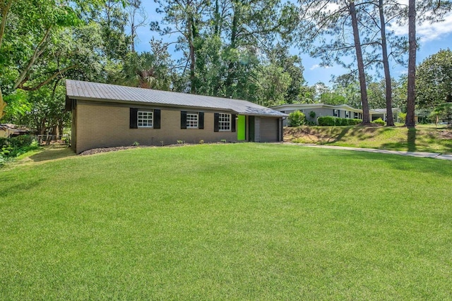2314 Oxford Rd, Tallahassee, FL 32304 - ranch-style home with a front lawn, metal roof, and a garage