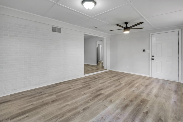 2314 Oxford Rd, Tallahassee, FL 32304 - spare room with wood finished floors, ceiling fan, brick wall, and baseboards