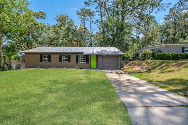 2314 Oxford Rd, Tallahassee, FL 32304 - view of front of property with a garage, concrete driveway, a front yard, metal roof, and a standing seam roof